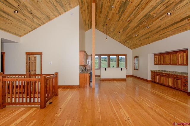 unfurnished living room with light wood-type flooring, beamed ceiling, high vaulted ceiling, and wooden ceiling