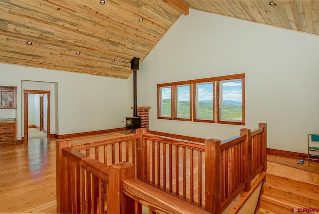 hall featuring high vaulted ceiling, wooden ceiling, and light hardwood / wood-style floors