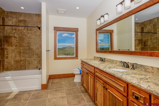 full bathroom featuring vanity, toilet, tile patterned floors, and tiled shower / bath