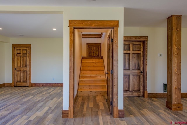 stairway with hardwood / wood-style flooring