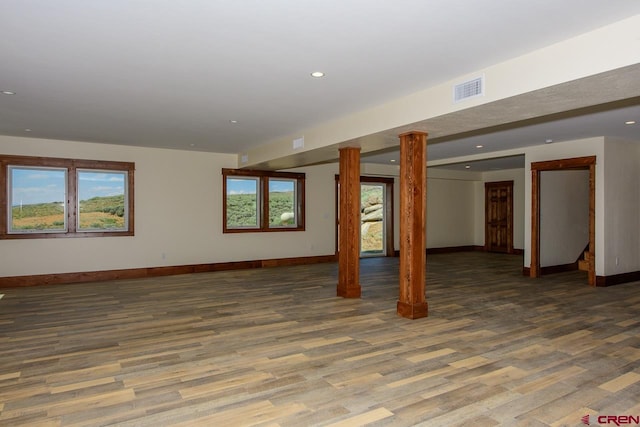 basement with a wealth of natural light and dark wood-type flooring