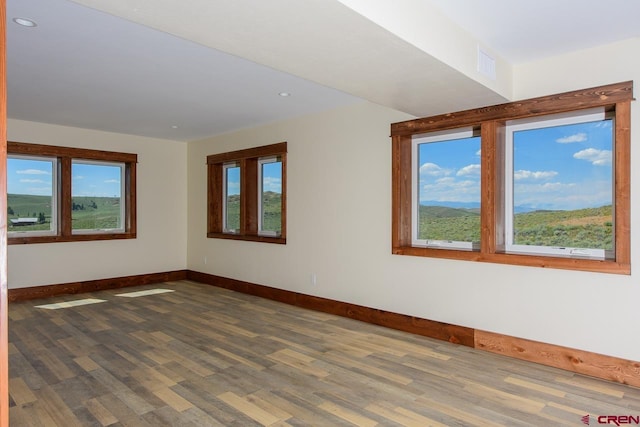 unfurnished room with dark hardwood / wood-style floors