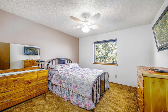 carpeted bedroom with a textured ceiling and ceiling fan