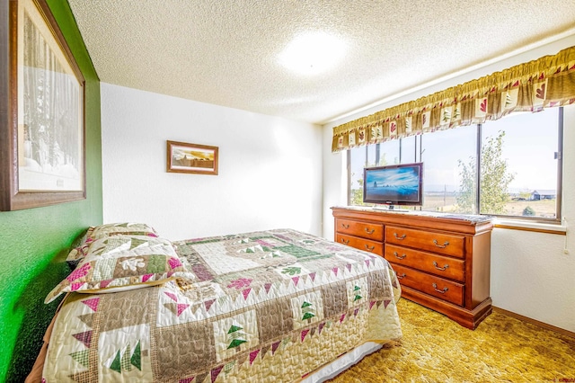 carpeted bedroom featuring a textured ceiling