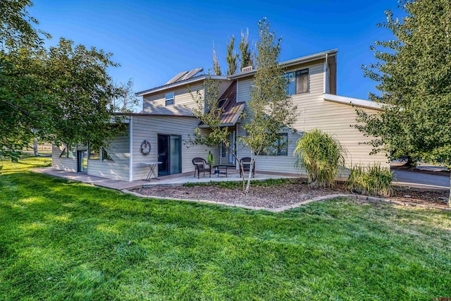 back of property featuring a yard and a patio area