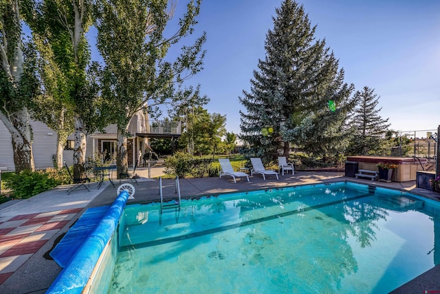 view of pool featuring a hot tub and a patio area