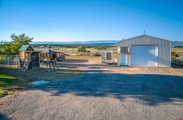 view of front of home with an outbuilding, a garage, and a mountain view