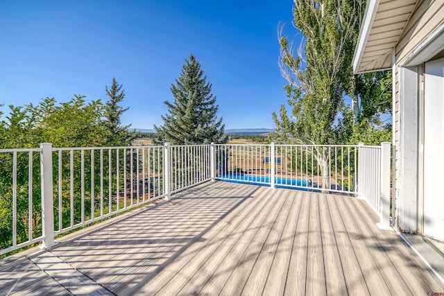 deck featuring a swimming pool