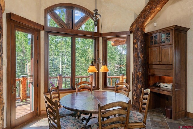 dining area featuring lofted ceiling with beams and a healthy amount of sunlight