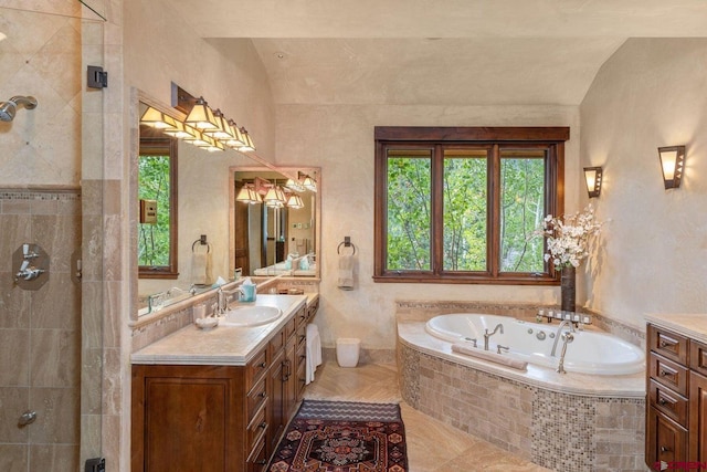 bathroom featuring vanity, tile patterned flooring, vaulted ceiling, and plus walk in shower