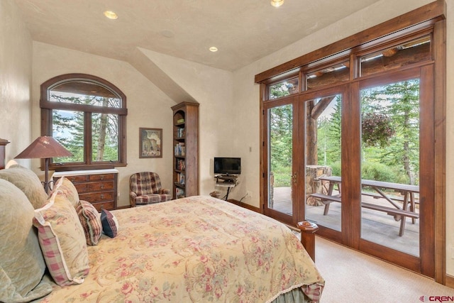 carpeted bedroom with lofted ceiling, french doors, and access to exterior