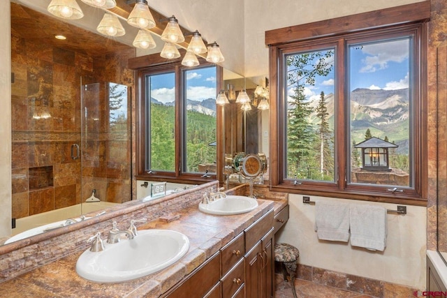 bathroom with a mountain view, plenty of natural light, and a shower with door