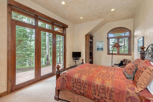 carpeted bedroom featuring vaulted ceiling, french doors, and access to outside