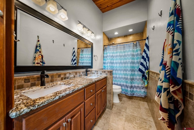 bathroom featuring vanity, backsplash, tile walls, toilet, and a shower with curtain