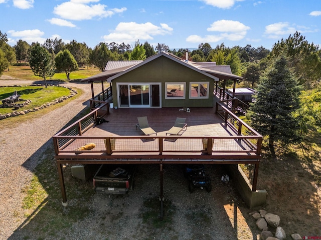 rear view of property featuring a wooden deck