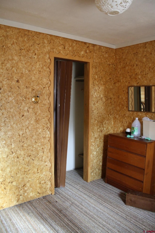 unfurnished bedroom featuring a closet and carpet flooring