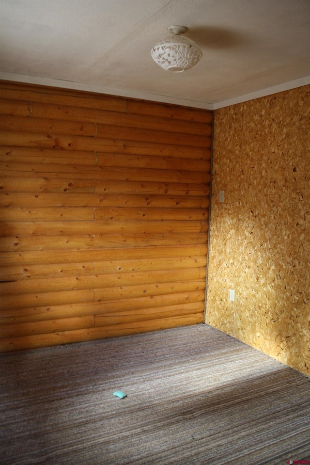 unfurnished room featuring rustic walls