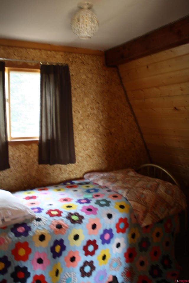 unfurnished bedroom with beam ceiling