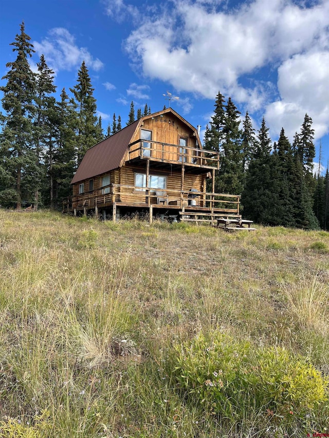 back of house with a wooden deck