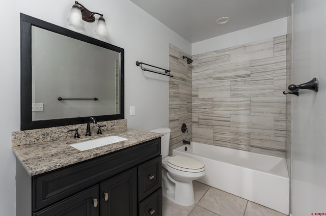 full bathroom featuring tiled shower / bath, vanity, toilet, and tile patterned floors