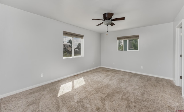 unfurnished room with ceiling fan and carpet floors