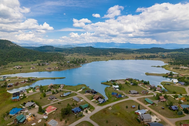 bird's eye view with a water and mountain view