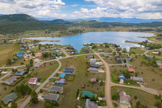 drone / aerial view with a water and mountain view