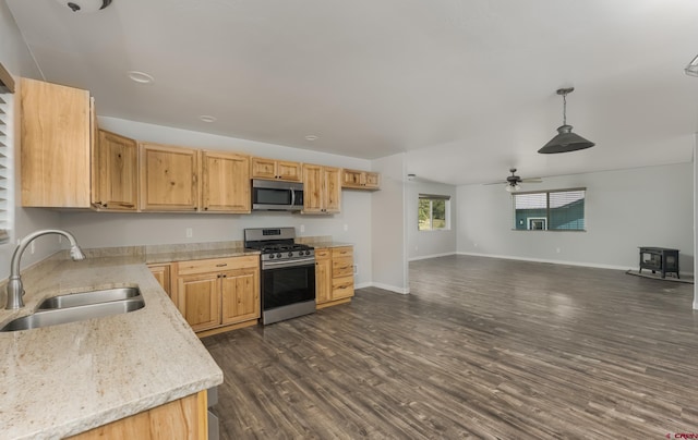 kitchen with decorative light fixtures, appliances with stainless steel finishes, dark wood-type flooring, sink, and ceiling fan