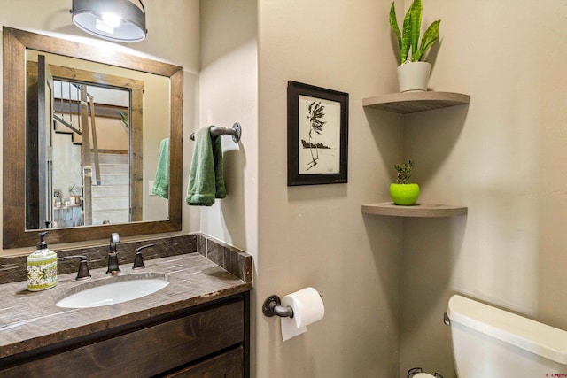 bathroom with toilet and vanity