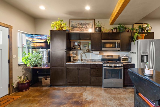 kitchen with dark brown cabinets, stainless steel appliances, and sink