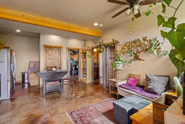 living room with ceiling fan, beam ceiling, and concrete floors