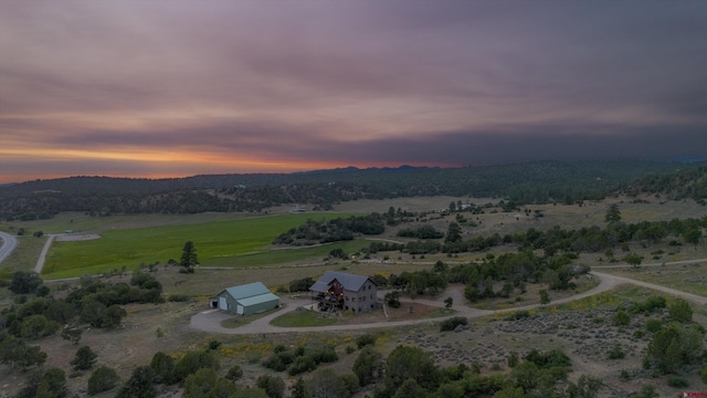 aerial view at dusk featuring a rural view