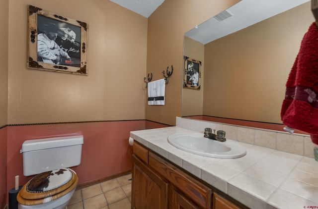 bathroom featuring tile patterned flooring, toilet, and vanity