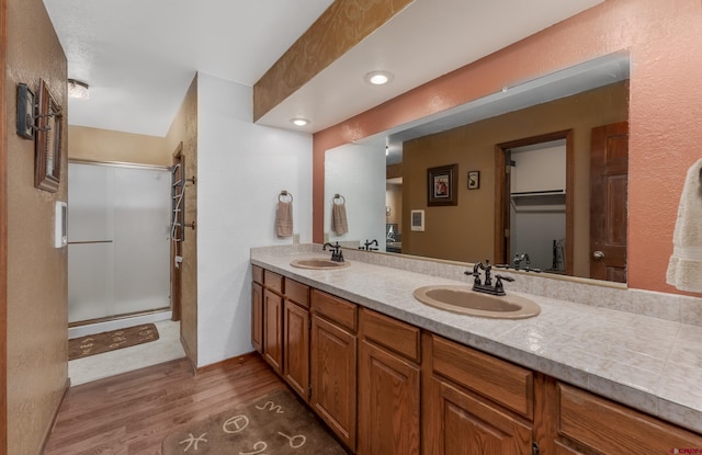 bathroom with vanity, hardwood / wood-style floors, and an enclosed shower