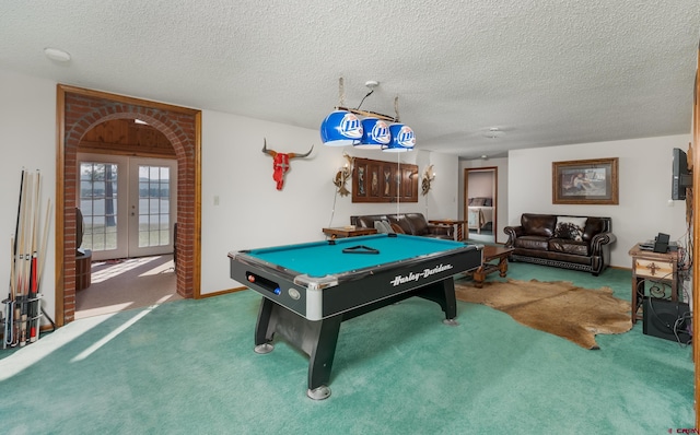 game room featuring a textured ceiling, carpet flooring, and french doors