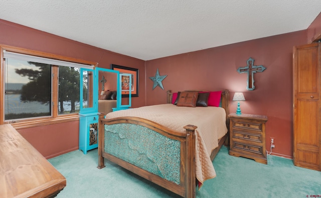 carpeted bedroom featuring a textured ceiling