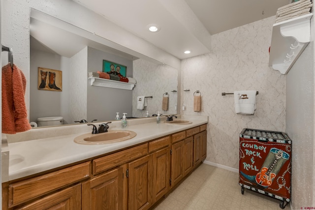 bathroom with toilet and vanity