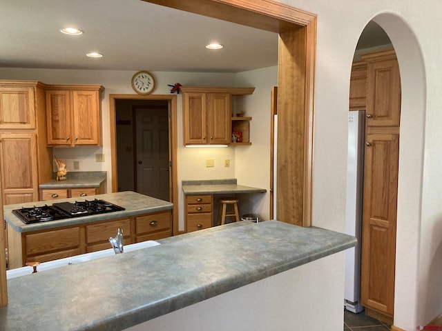 kitchen with stainless steel appliances and dark tile patterned floors