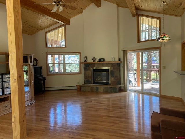 living room with ceiling fan, hardwood / wood-style flooring, plenty of natural light, and wooden ceiling