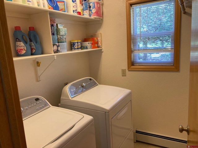 laundry area with baseboard heating and washing machine and clothes dryer