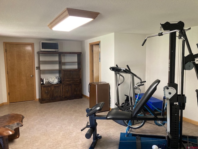 exercise area featuring a textured ceiling