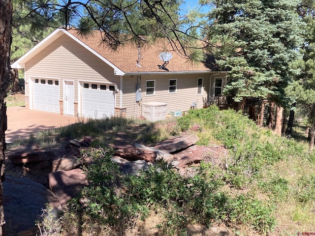 view of side of home with a garage