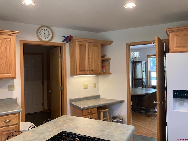 kitchen featuring dark hardwood / wood-style flooring and white refrigerator with ice dispenser