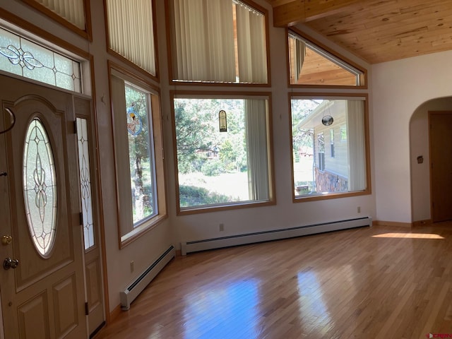 entryway featuring a baseboard heating unit, wood ceiling, and light hardwood / wood-style floors