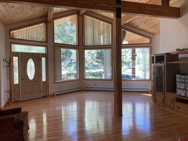 entryway featuring a baseboard heating unit, beamed ceiling, and light wood-type flooring