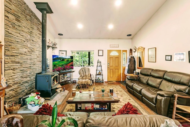 living room featuring a wood stove and hardwood / wood-style flooring