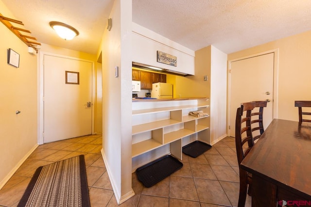 interior space featuring a textured ceiling and tile patterned floors