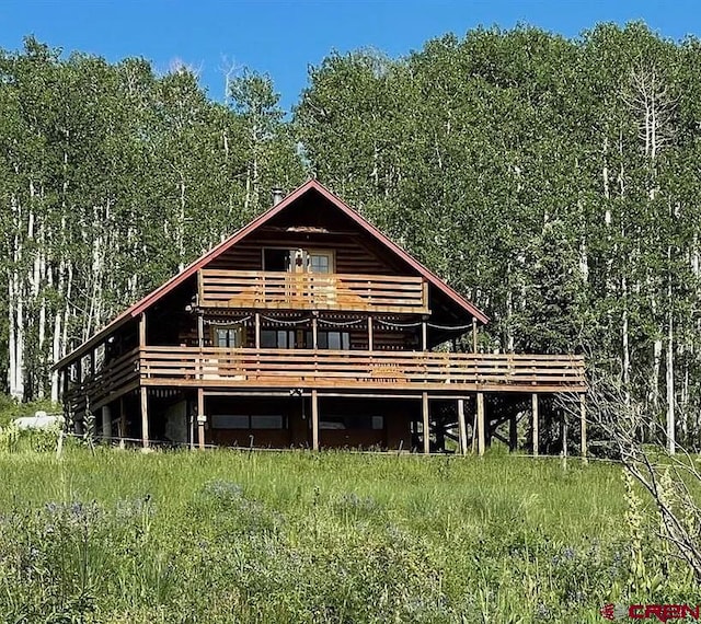 rear view of property with a wooden deck