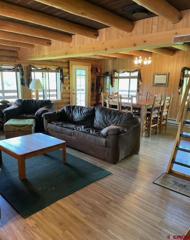 living room with wooden ceiling, wood-type flooring, wooden walls, and beamed ceiling