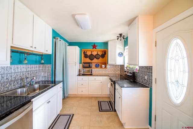 kitchen featuring stainless steel appliances, backsplash, sink, and white cabinetry